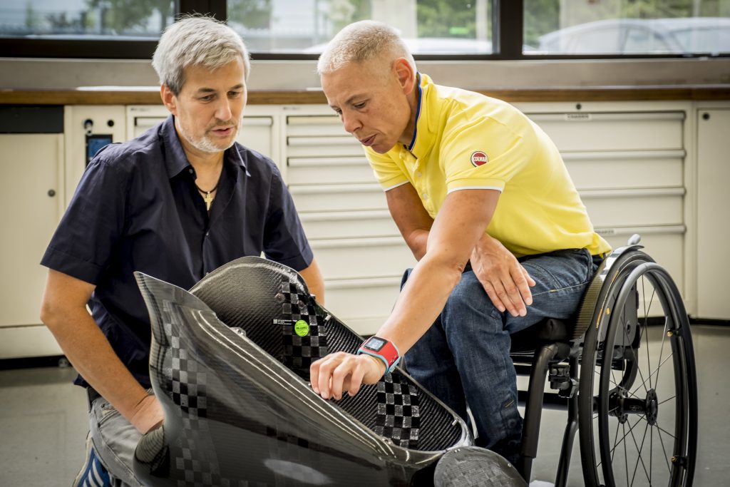 Para athlete Andrea Eskau works with Toyota engineers as they review equipment under development.